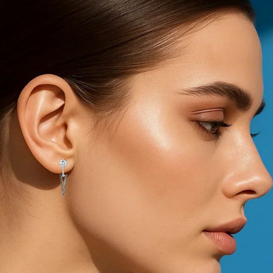 Woman wearing earrings with a blue background