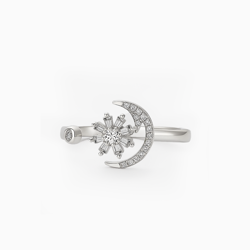 Silver ring with snowflake and moon design on a white background