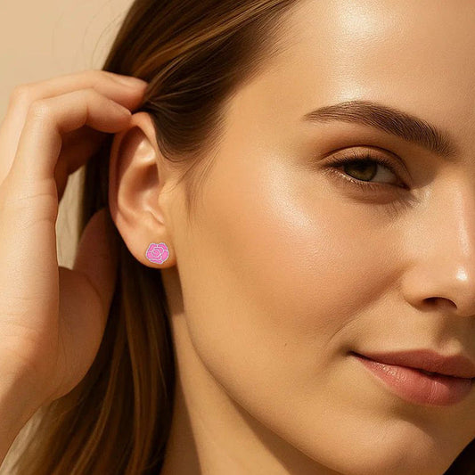 Close-up of a woman wearing a pink earring with a beige background