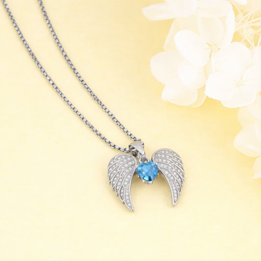 Necklace with angel wing pendant featuring a blue gemstone on a yellow background