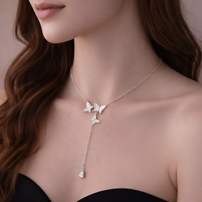 Butterfly necklace worn by a model with a neutral background