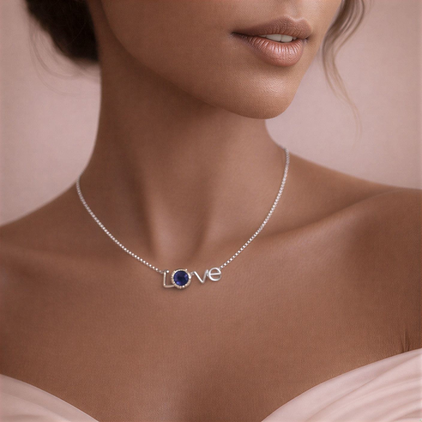 Necklace with 'LOVE' pendant on a model against a neutral background