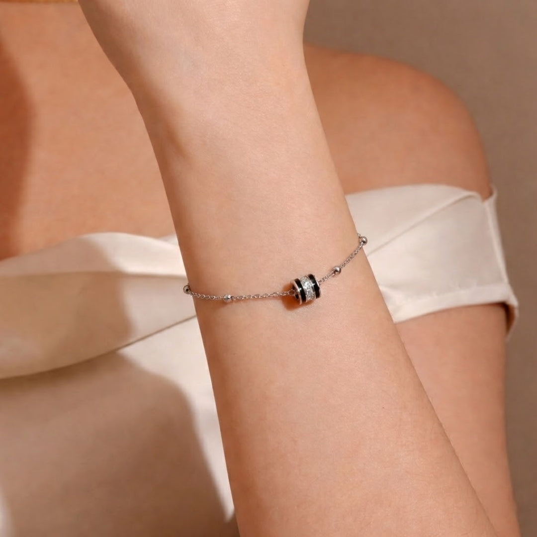 Close-up of a wrist wearing a bracelet with a neutral background