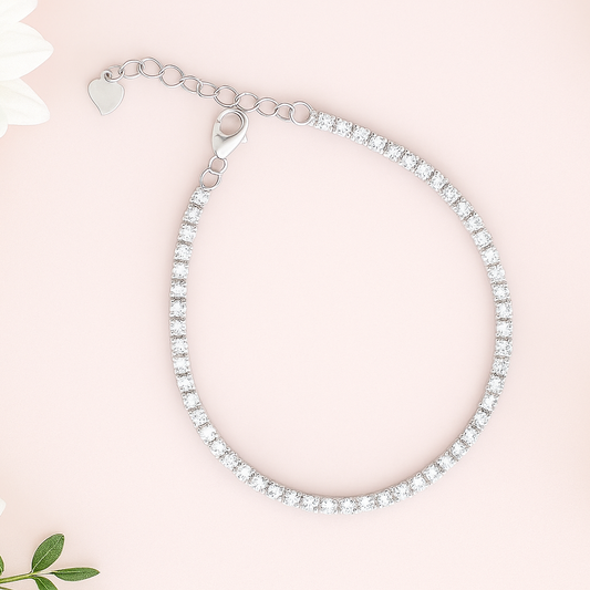 Silver bracelet on a pink background with white flowers