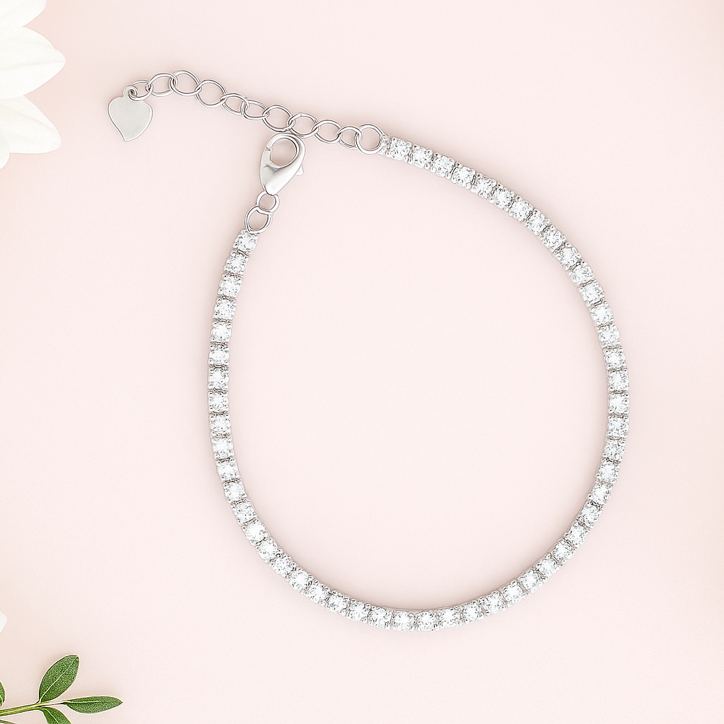 Silver bracelet on a pink background with white flowers