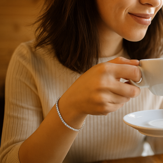 Woman holding a white teacup and saucer in a cozy indoor settings