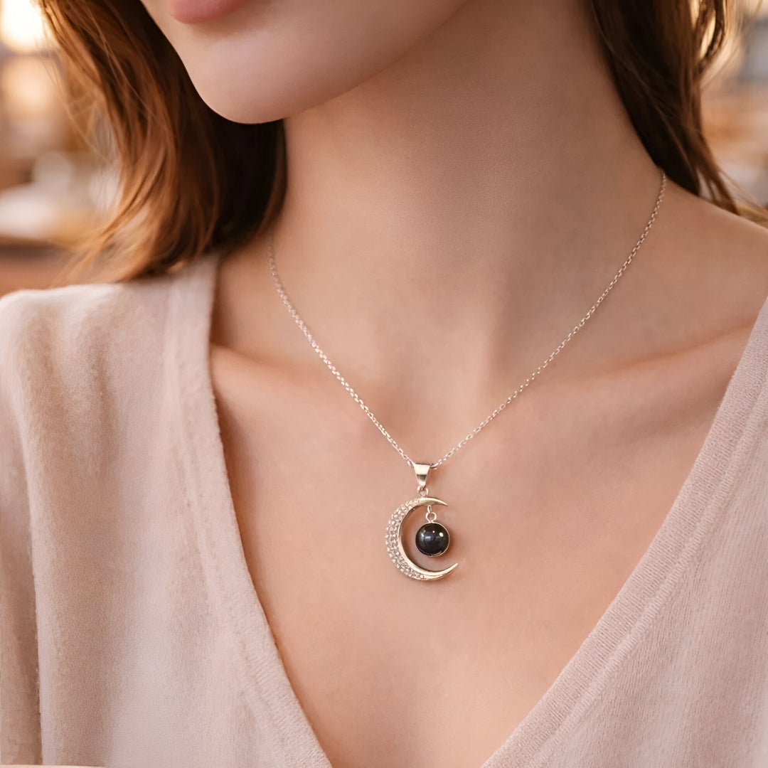 Necklace with a black pendant worn by a person