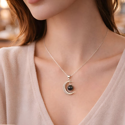 Necklace with a black pendant worn by a person