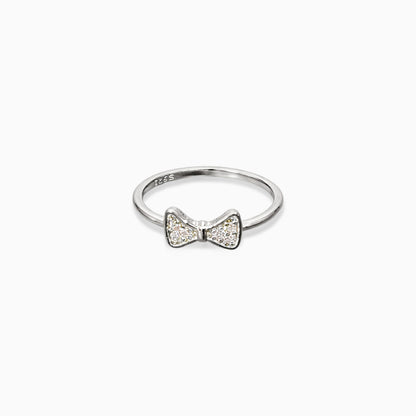 Silver ring with a bow design on a white background