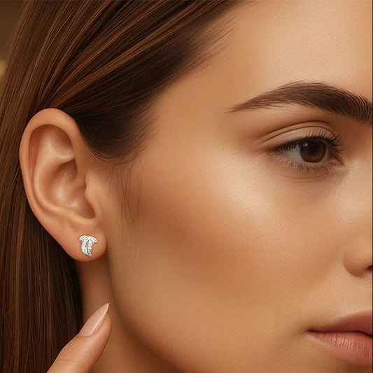 Close-up of a woman wearing a silver earring with a blurred background