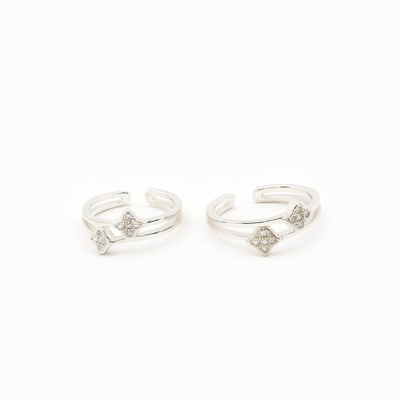 Pair of silver open rings with bow designs on a white background