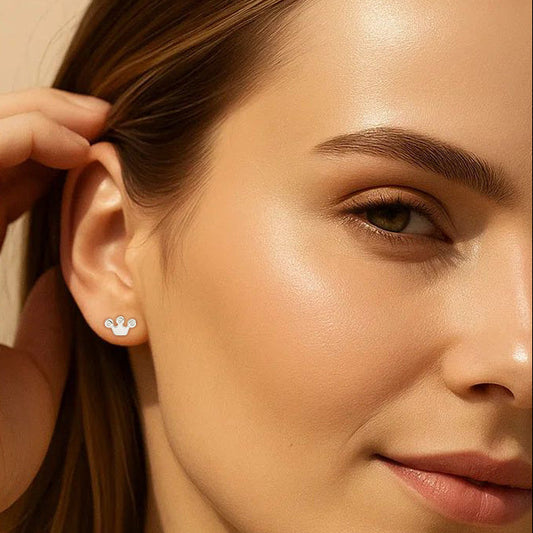 Close-up of a woman wearing a small earring with a paw print design.