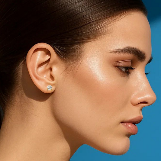 Woman wearing earrings against a blue background