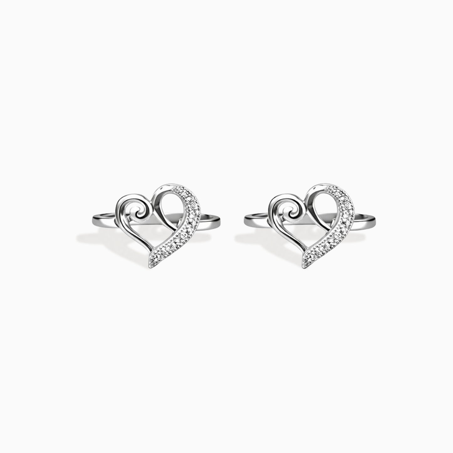 Heart-shaped silver earrings on a white background