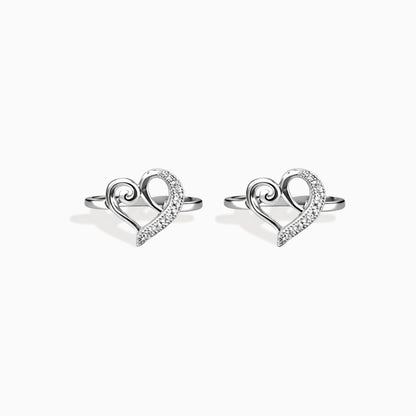 Heart-shaped silver earrings on a white background