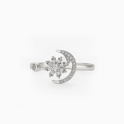 Silver ring with snowflake and moon design on a white background
