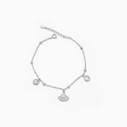 Silver bracelet with fan-shaped charm on a white background
