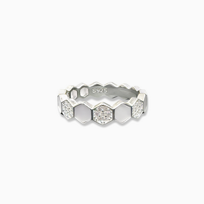 Silver ring with geometric design on a white background