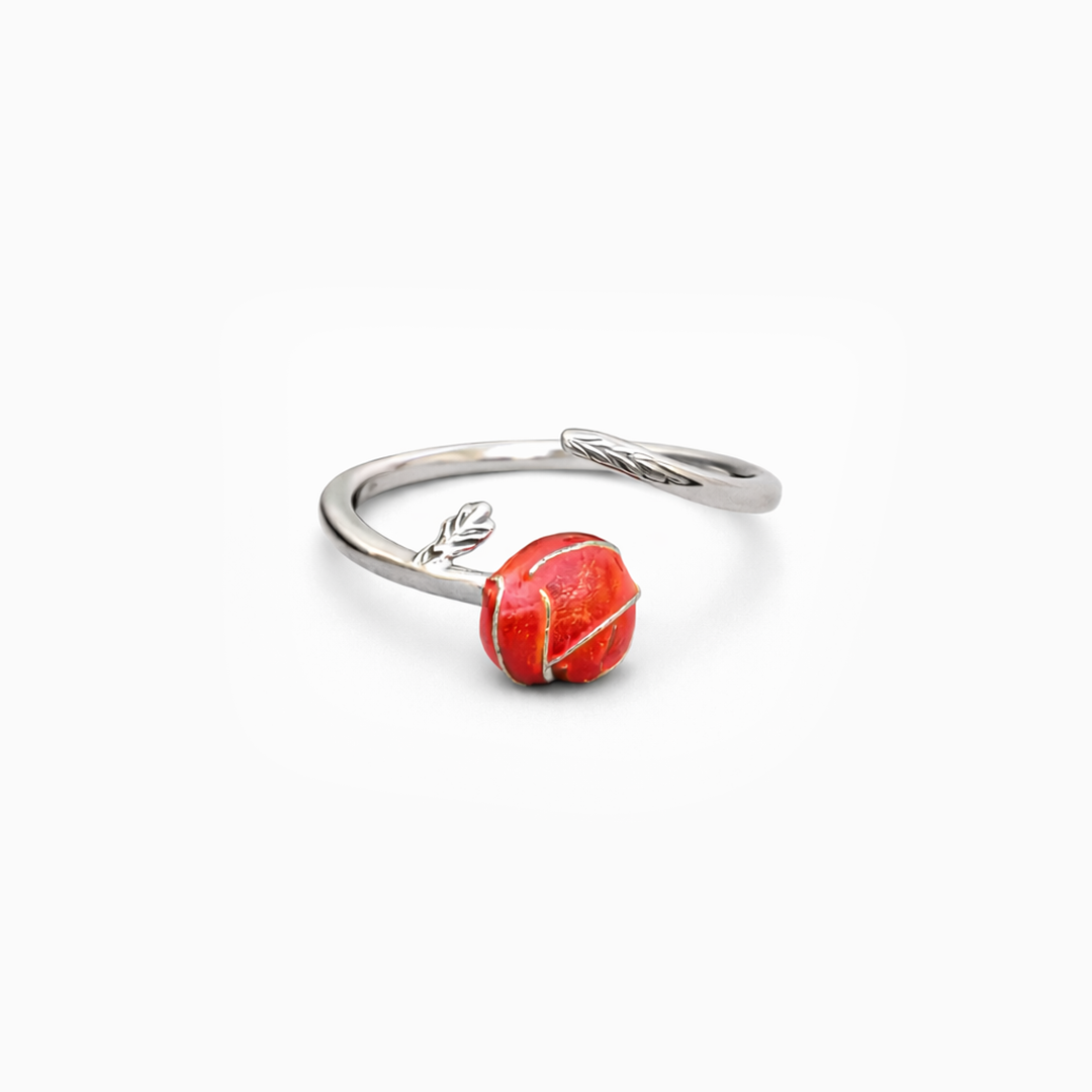 Silver ring with a red stone on a white background