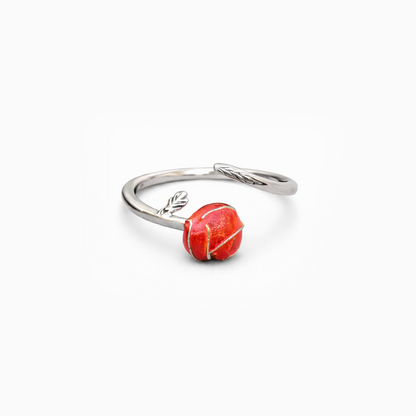 Silver ring with a red stone on a white background