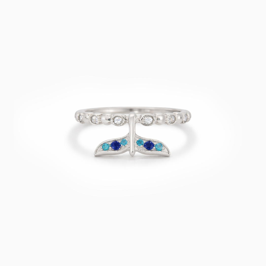 Silver ring with blue gemstones on a white background