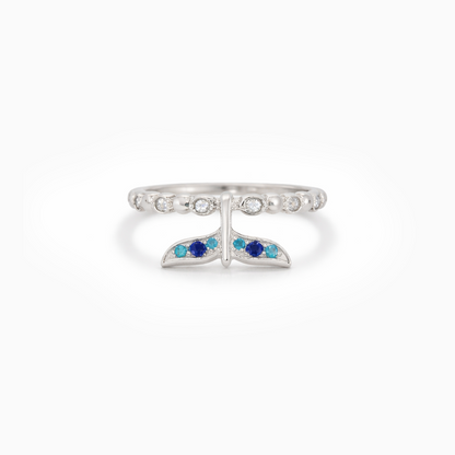 Silver ring with blue gemstones on a white background