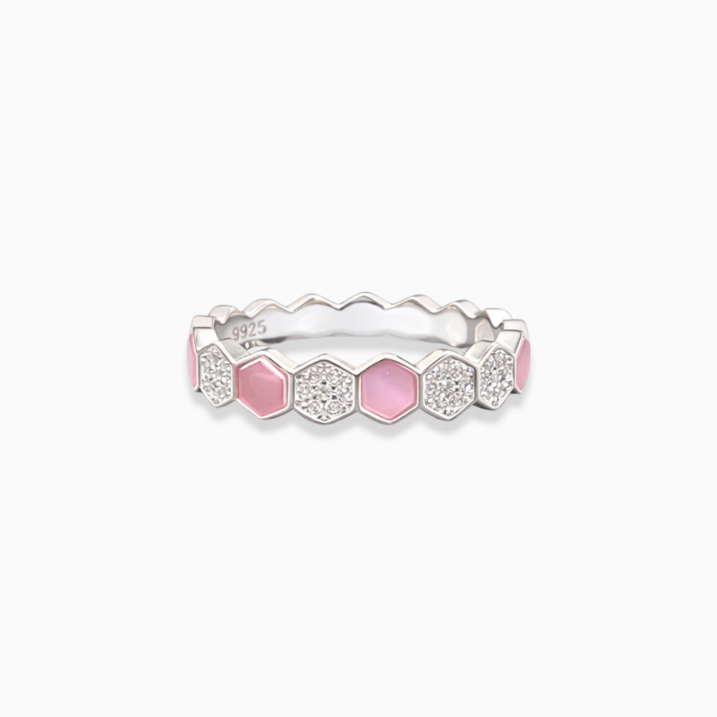 Silver ring with pink and clear gemstones on a white background