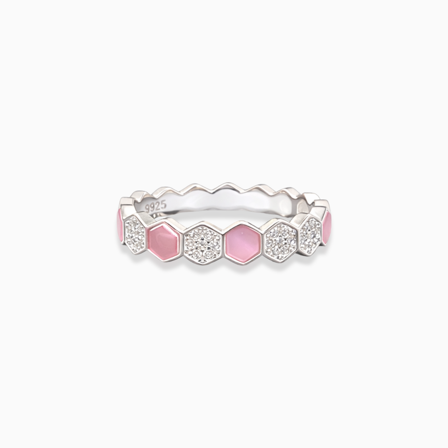 Silver ring with pink and clear gemstones on a white background
