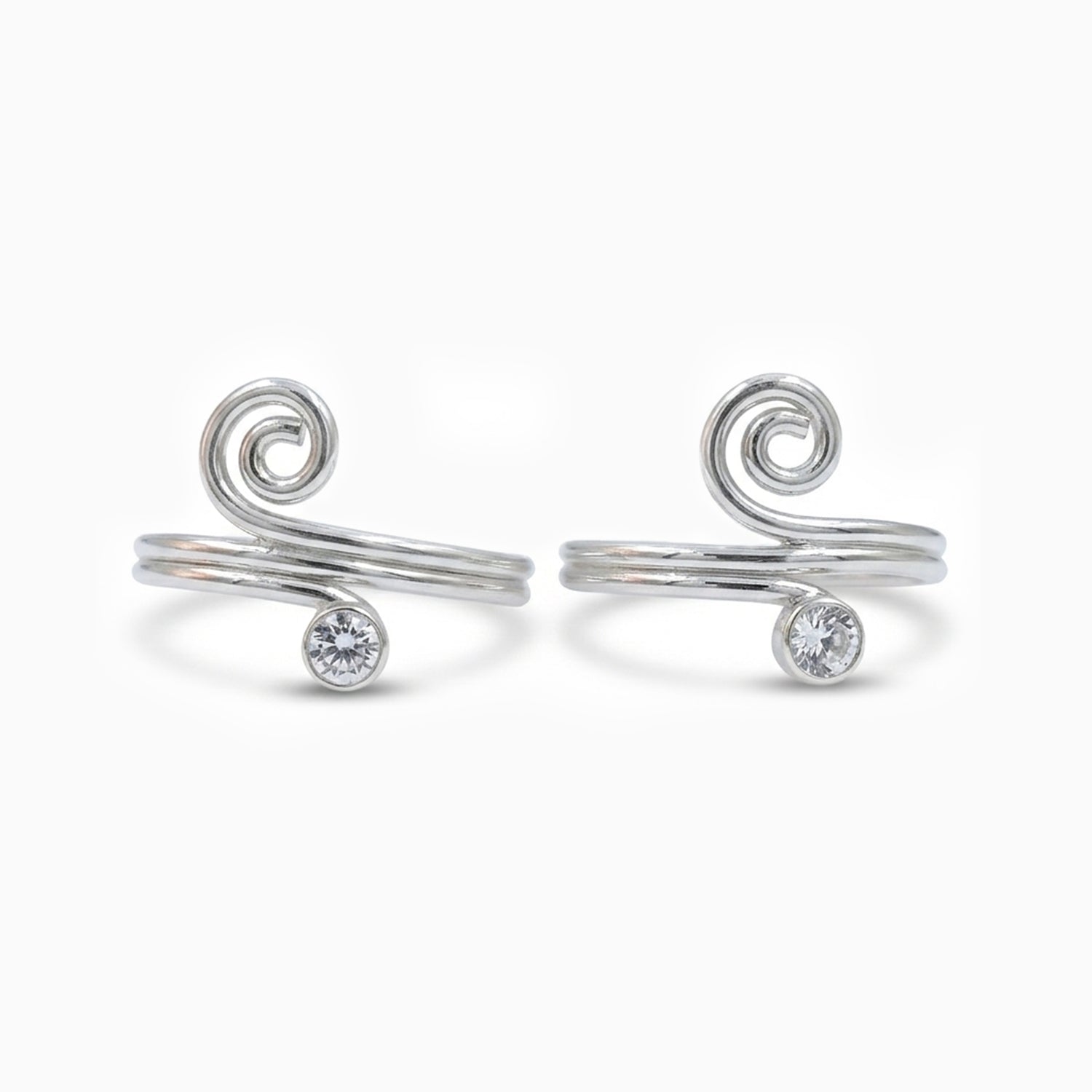 Pair of silver spiral toe rings with small gemstones on a white background