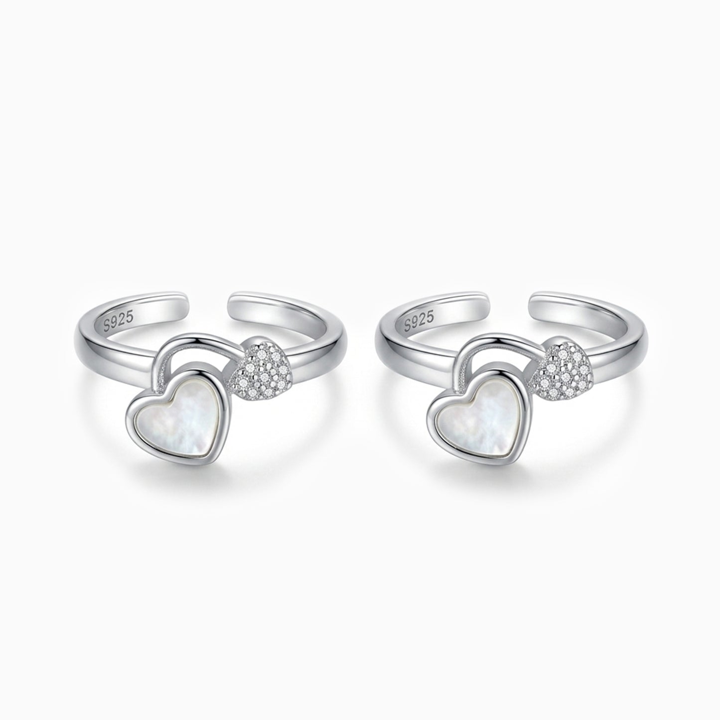 Two silver heart-shaped rings with embedded stones on a white background