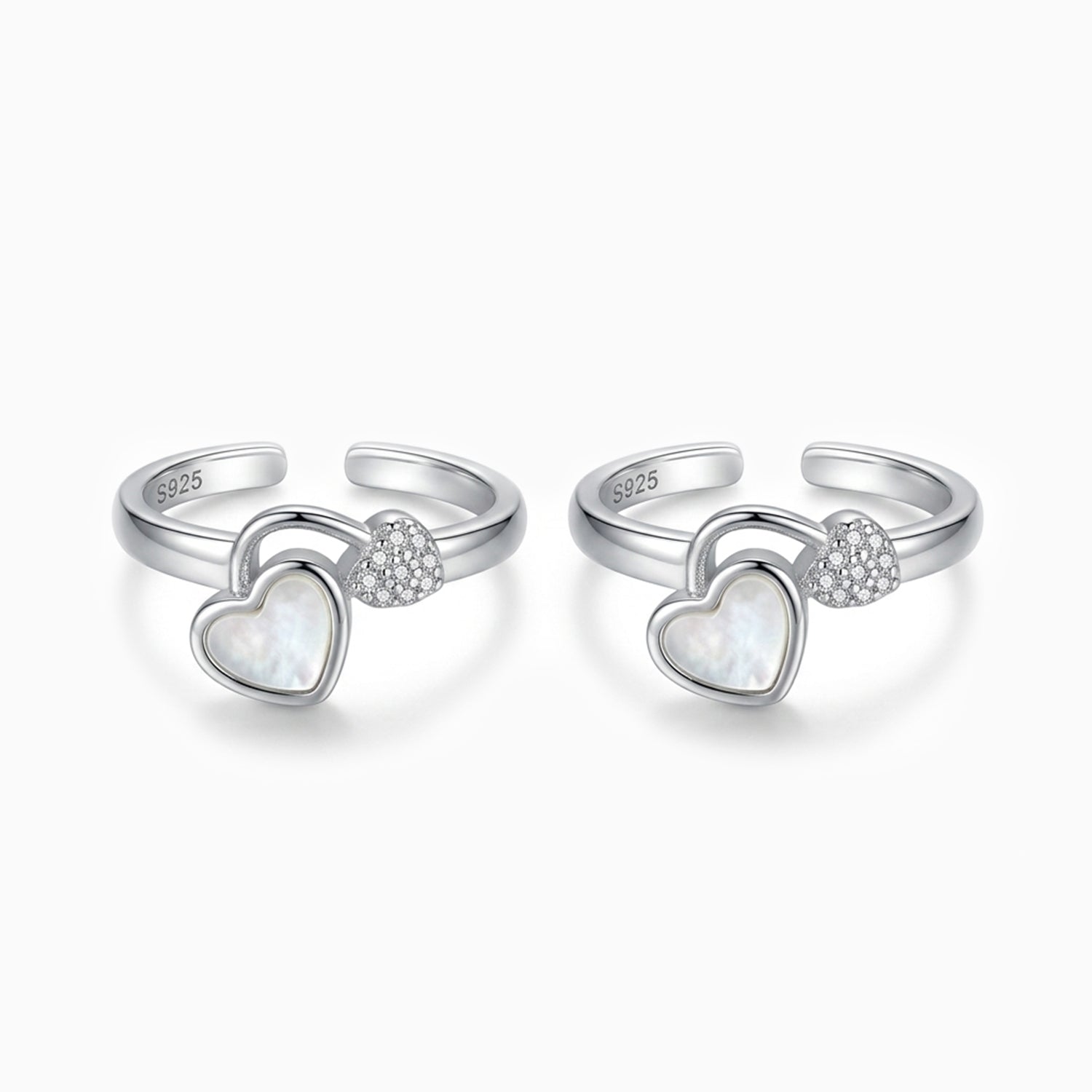 Two silver heart-shaped rings with embedded stones on a white background