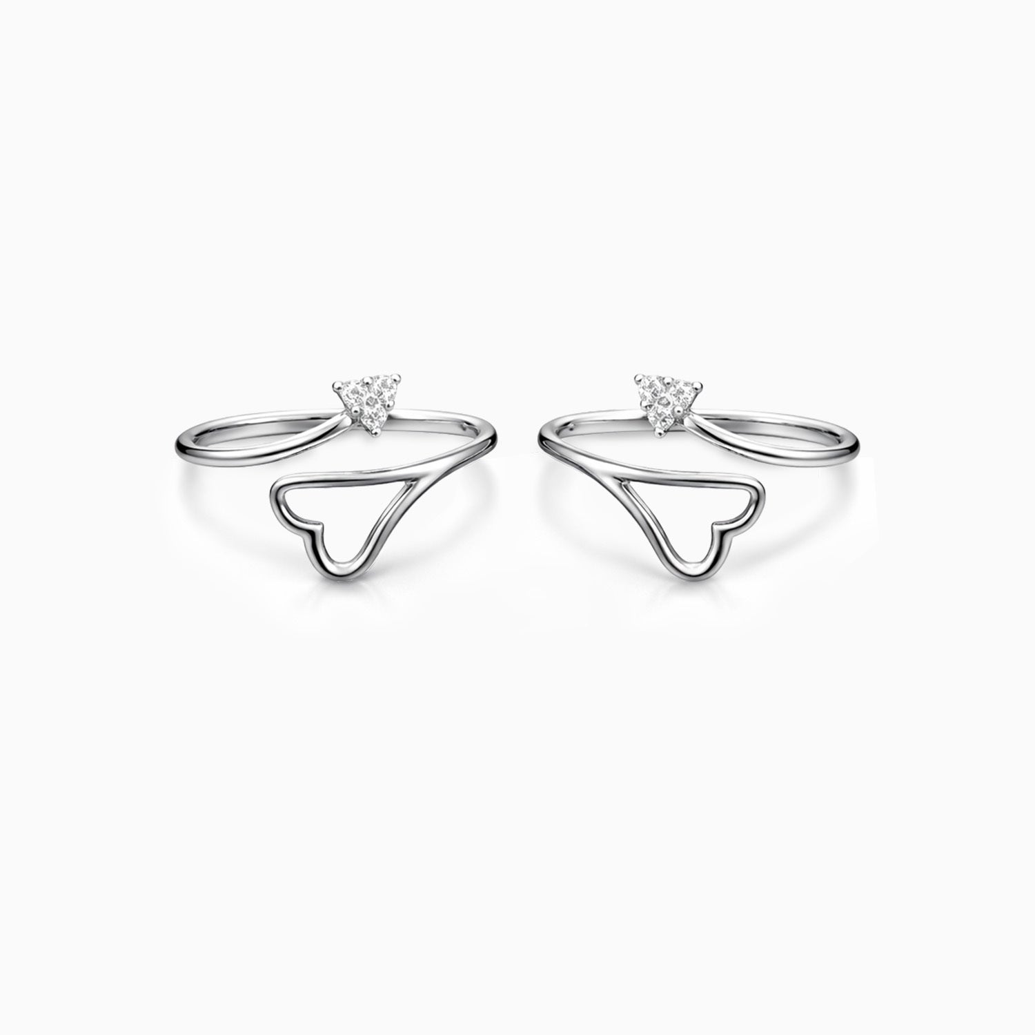 Silver ring with heart-shaped design and gemstone on a white background