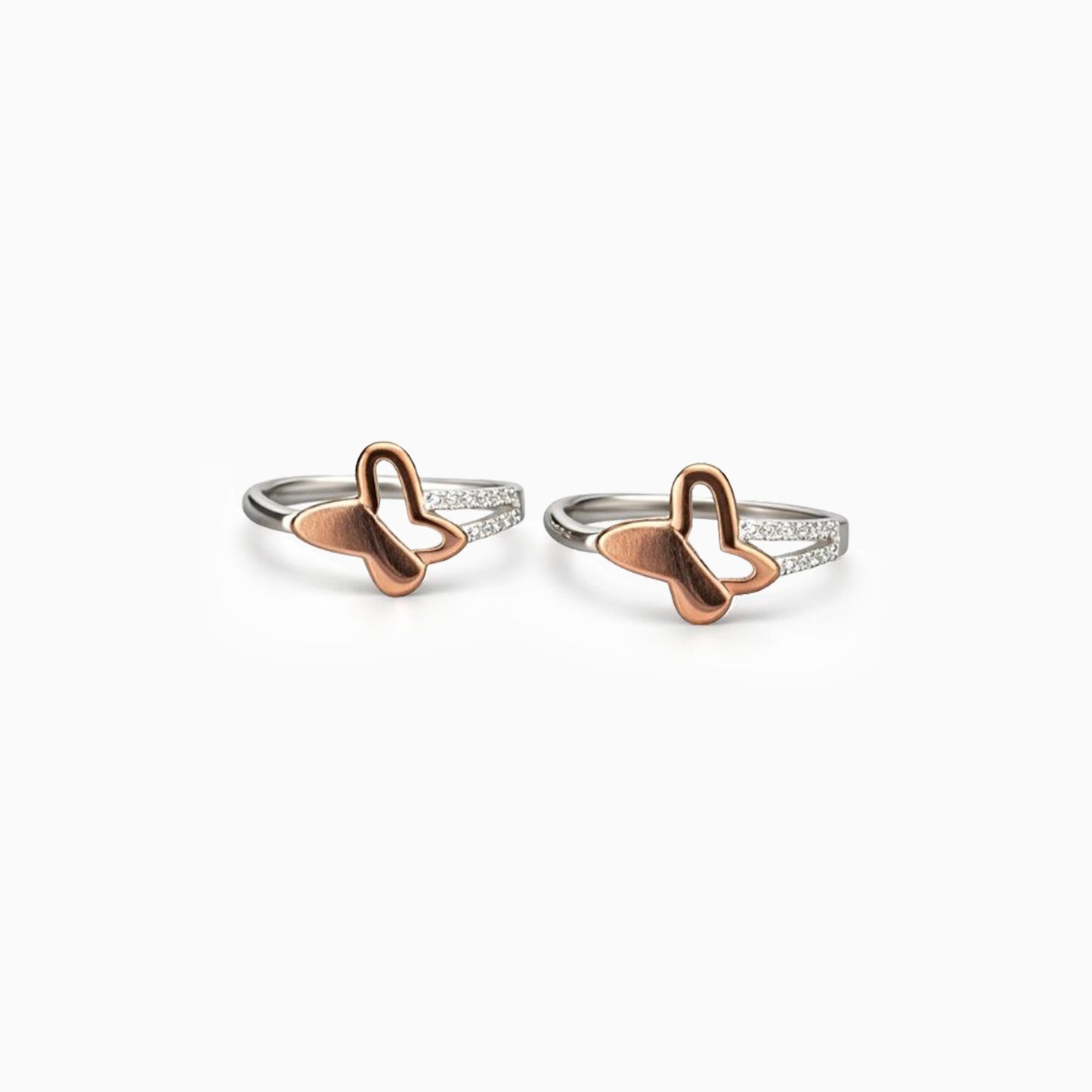 Two butterfly-shaped rings on a white background