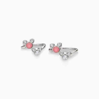 Pair of silver rings with pink gemstones on a white background
