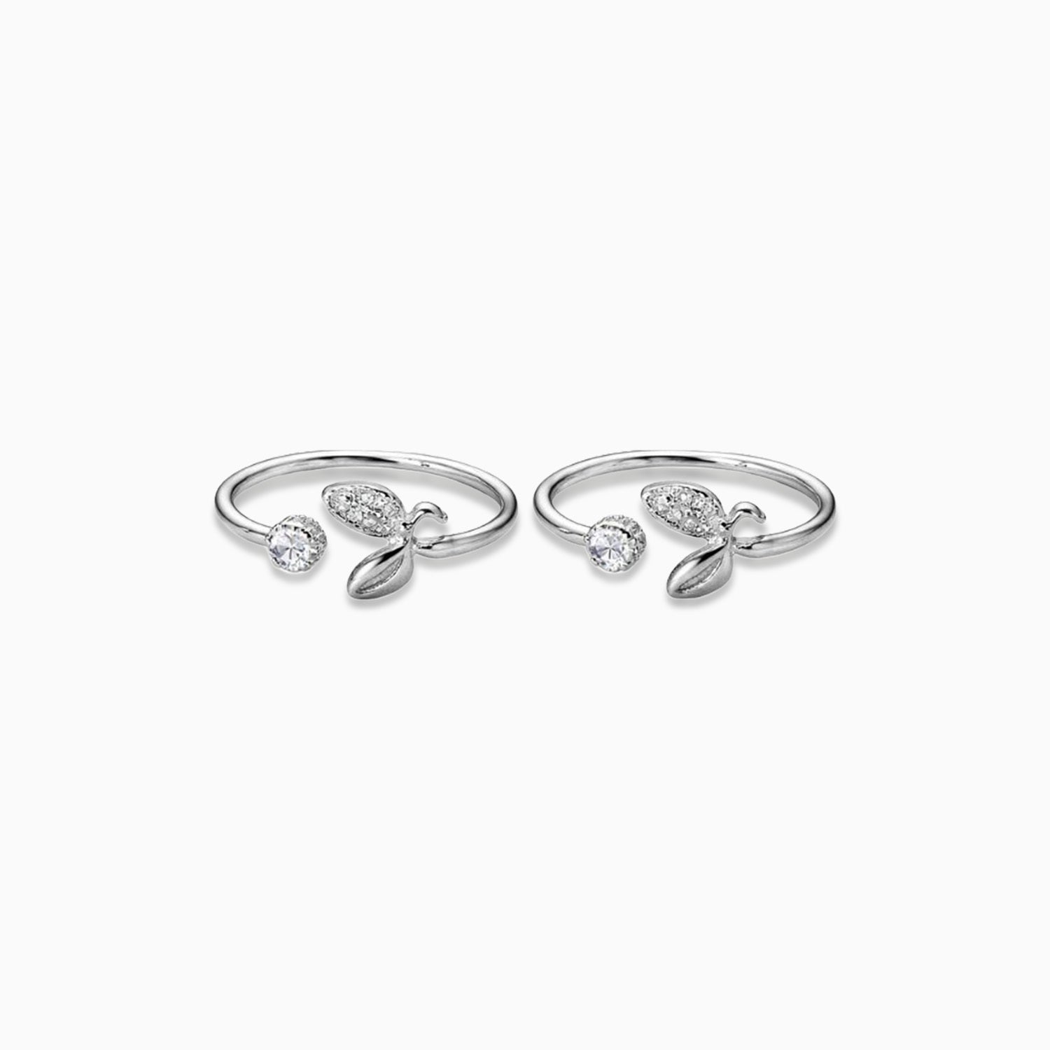 Pair of silver rings with gemstones on a white background