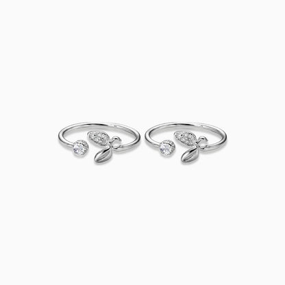 Pair of silver rings with gemstones on a white background