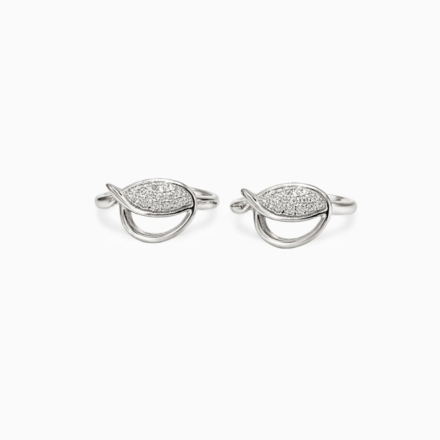 Pair of silver earrings with diamond-like stones on a white background