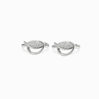 Pair of silver earrings with diamond-like stones on a white background
