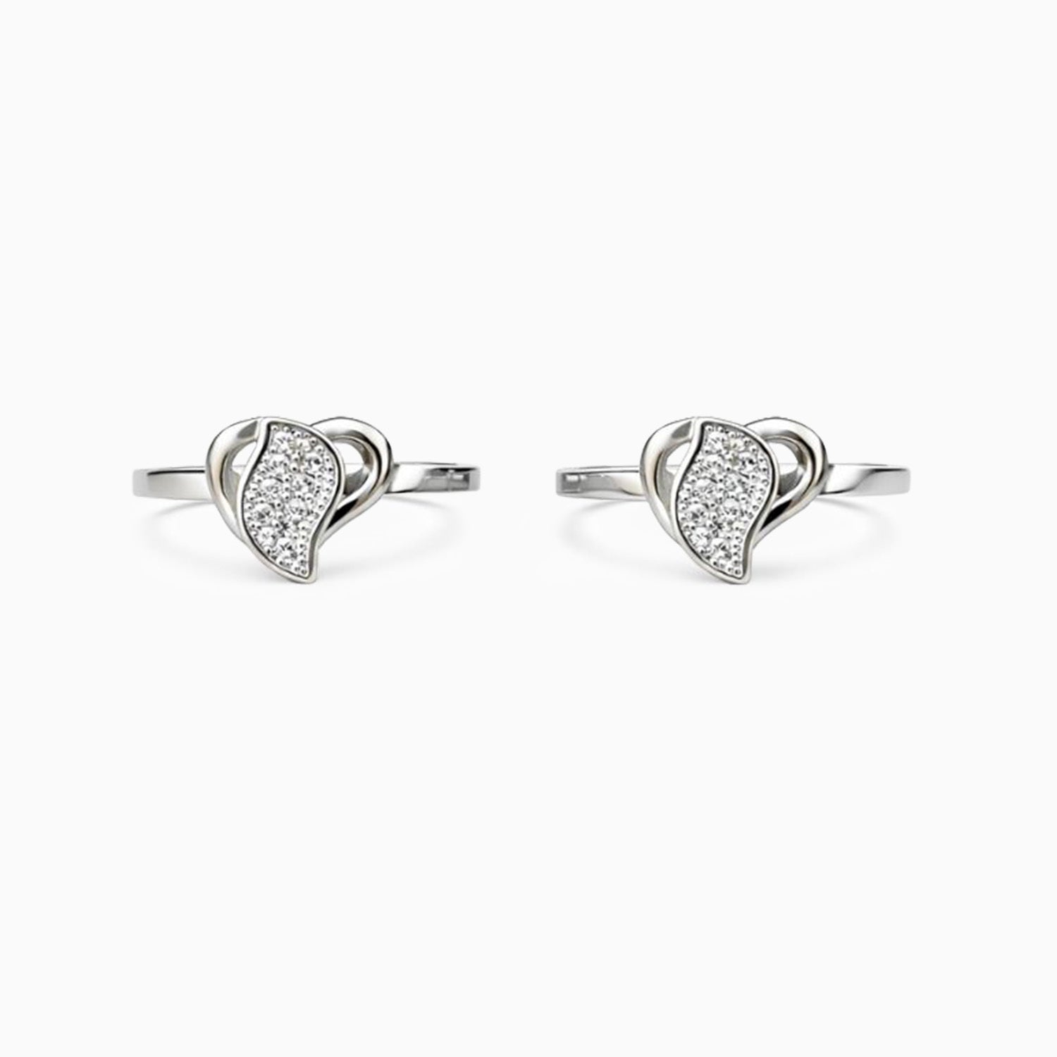 Pair of silver earrings with heart-shaped designs on a white background