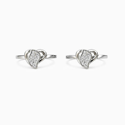 Pair of silver earrings with heart-shaped designs on a white background