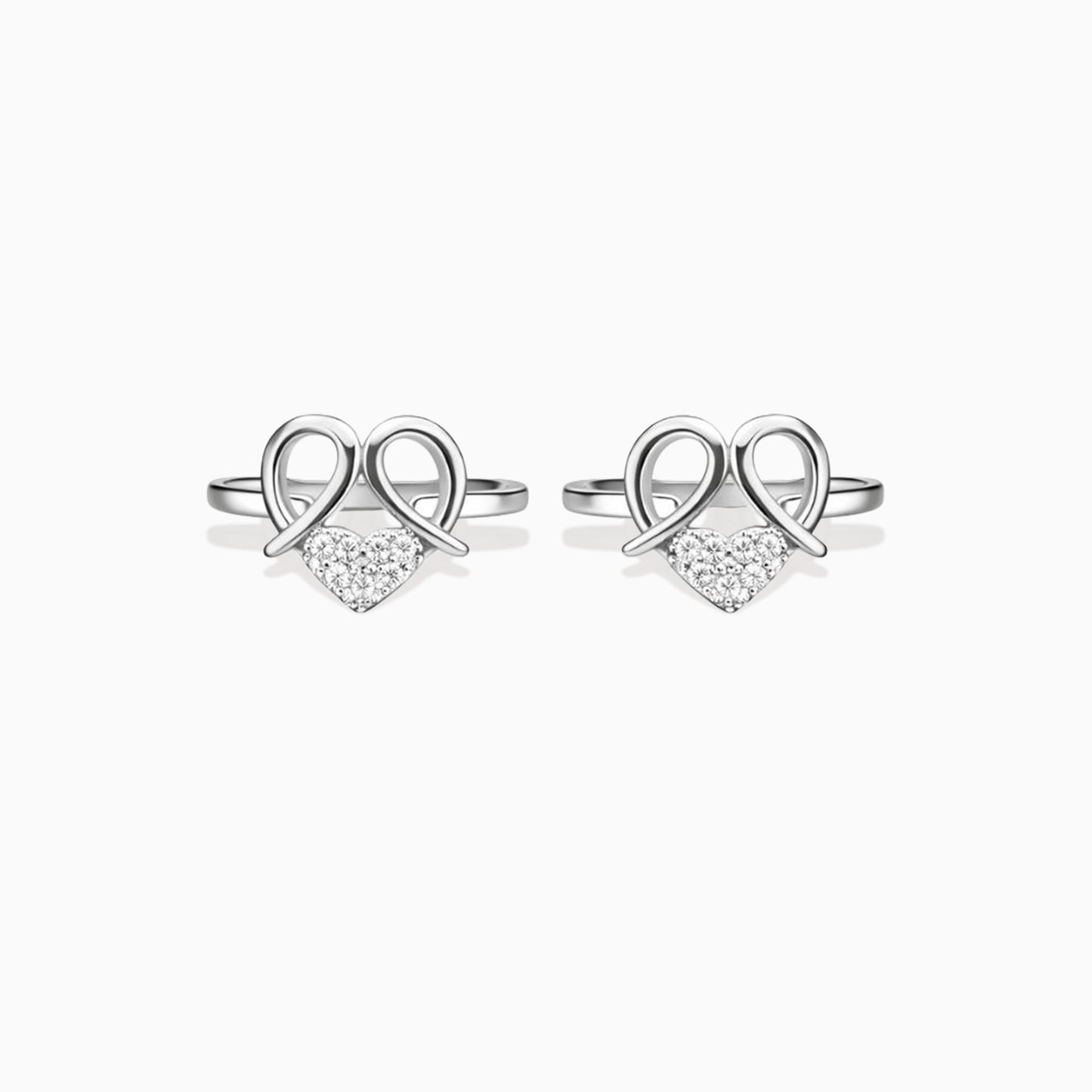 Pair of silver heart-shaped earrings with clear stones on a white background