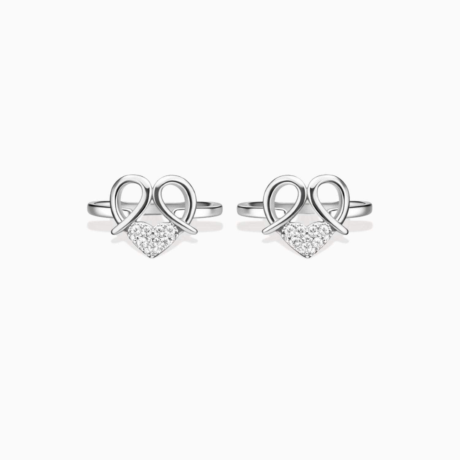 Pair of silver heart-shaped earrings with clear stones on a white background