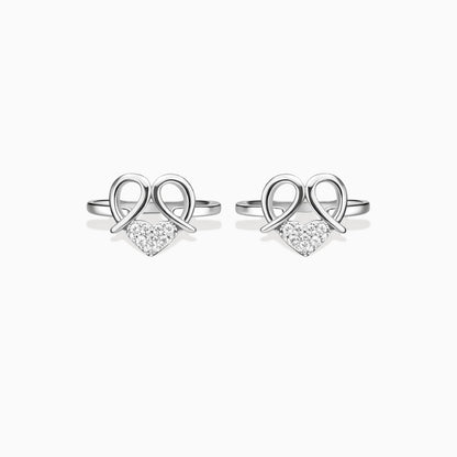 Pair of silver heart-shaped earrings with clear stones on a white background