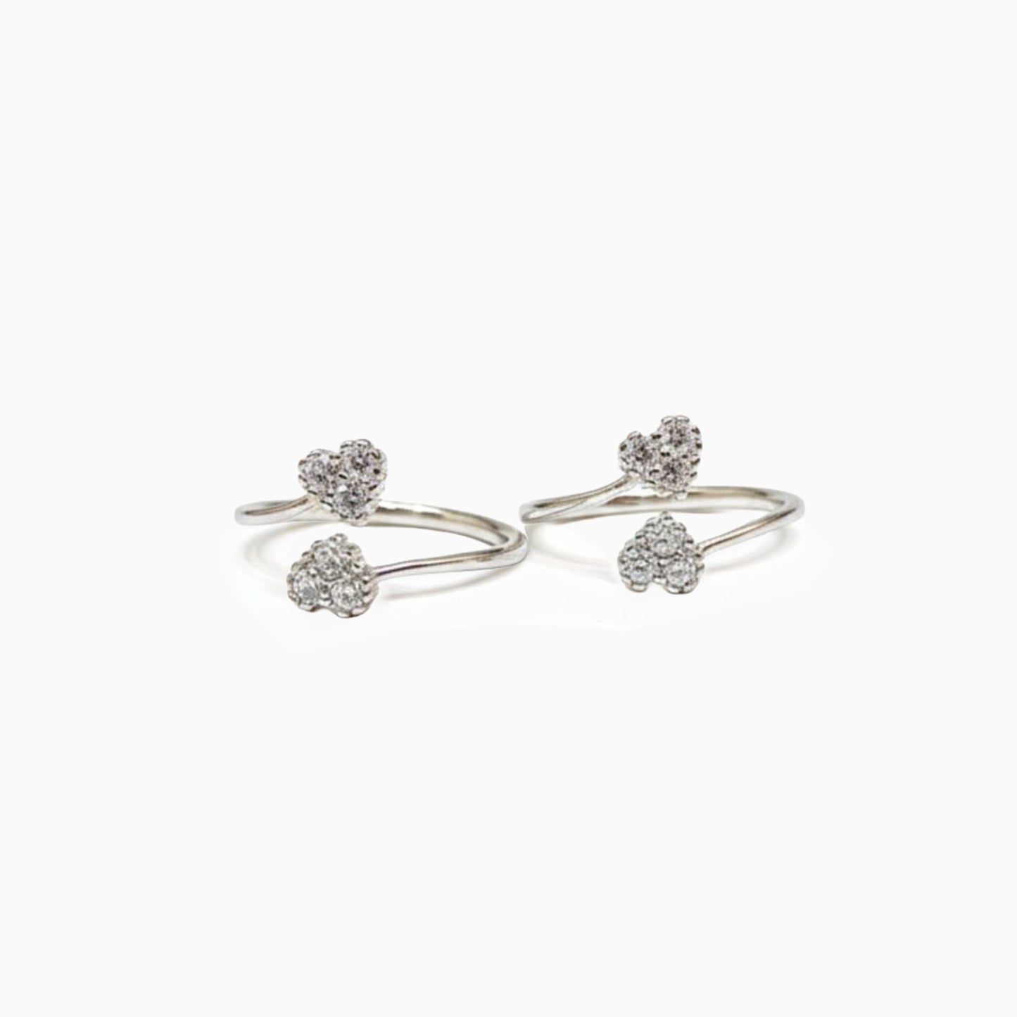 Pair of silver open ring with heart-shaped stones on a white background