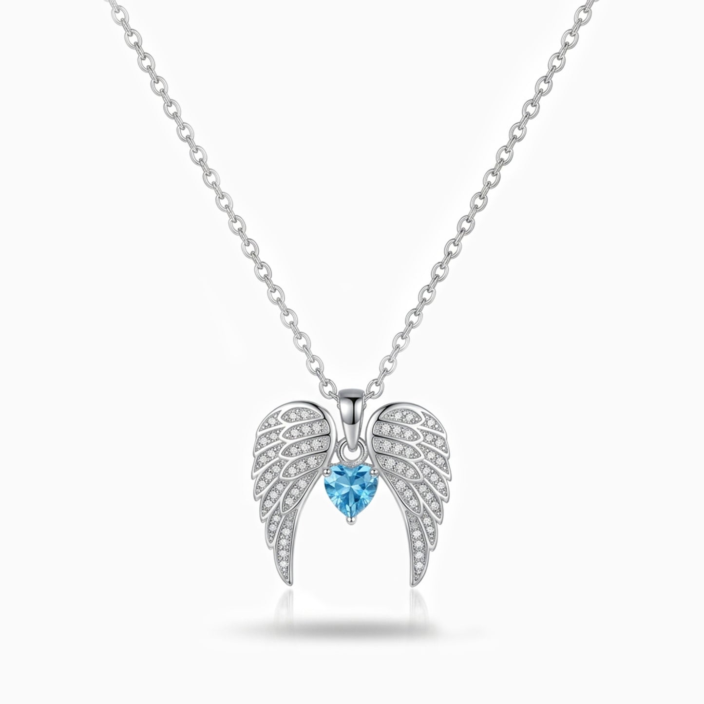 Silver angel wing necklace with a blue gemstone on a white background
