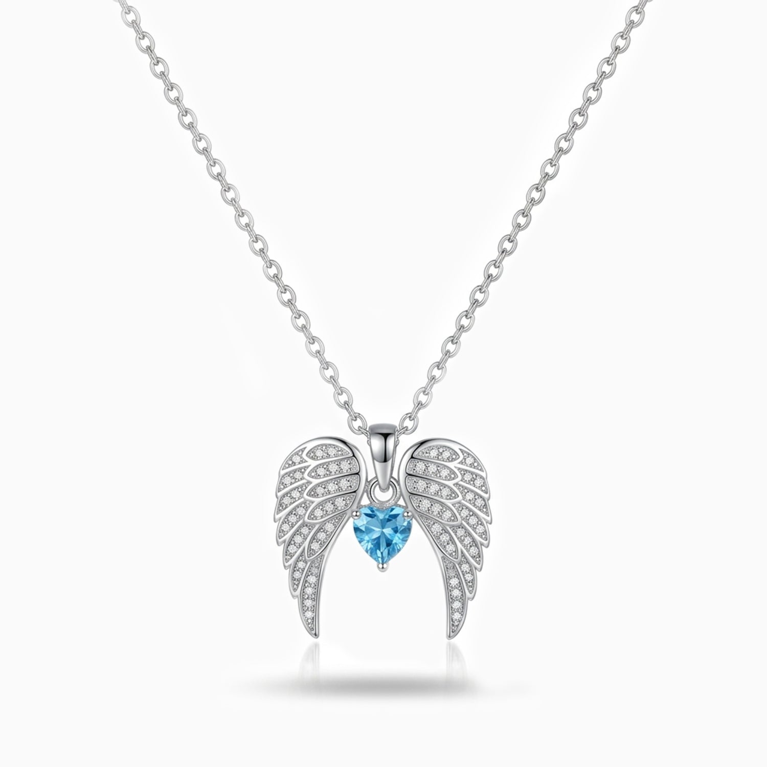 Silver angel wing necklace with a blue gemstone on a white background
