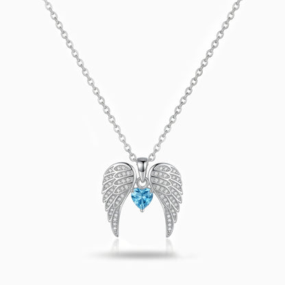 Silver angel wing necklace with a blue gemstone on a white background