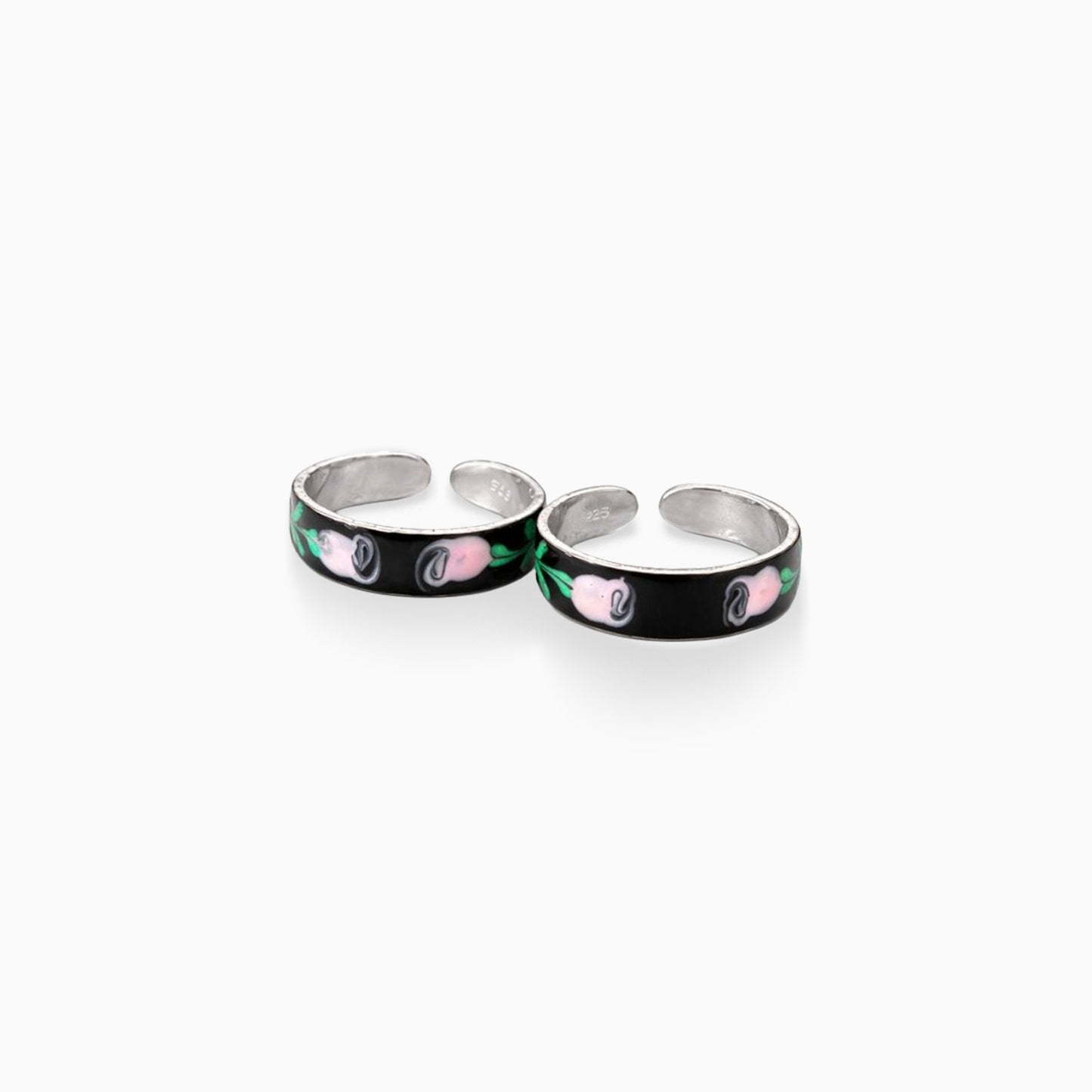 Two silver rings with black bands featuring pink and green designs on a white background