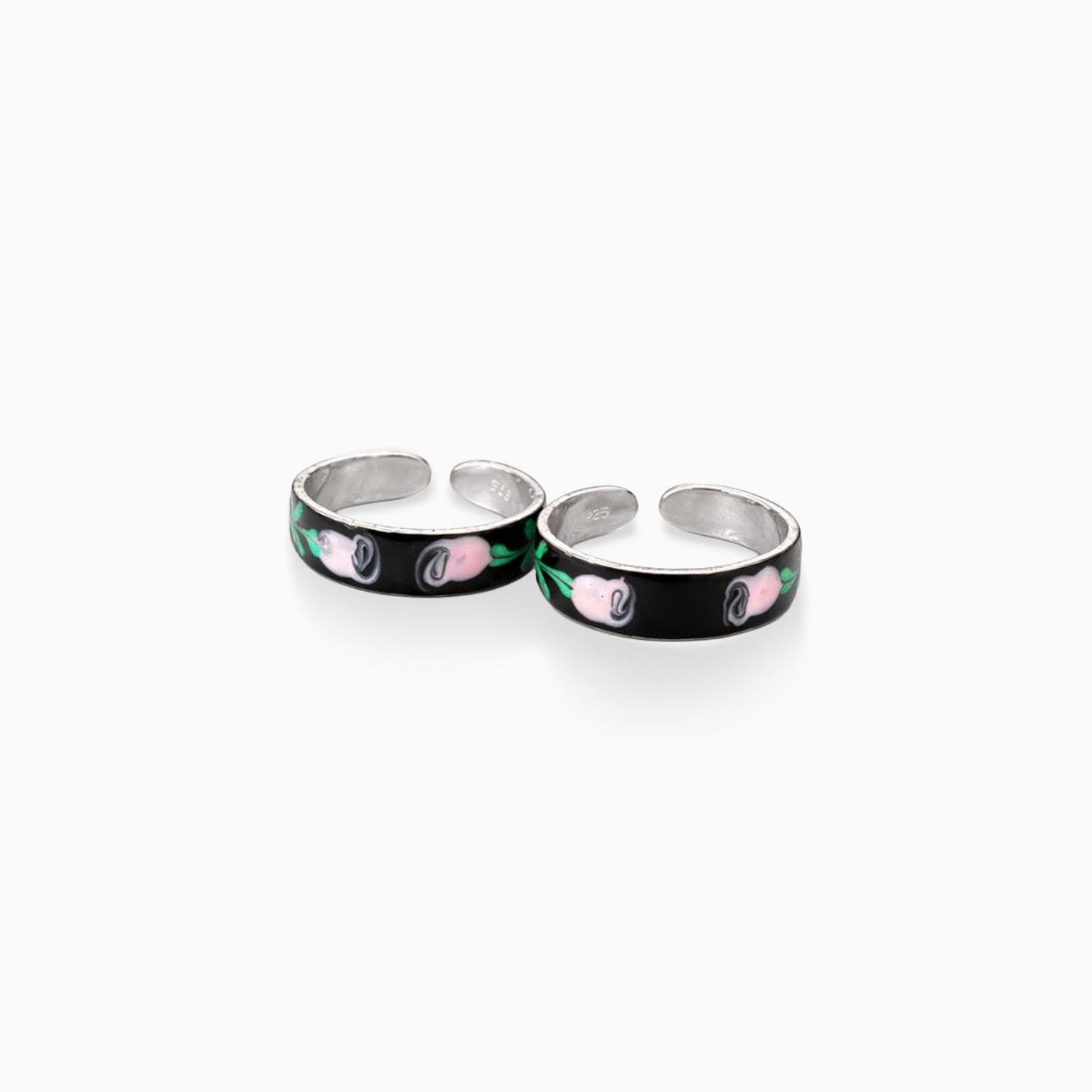 Two silver rings with black bands featuring pink and green designs on a white background