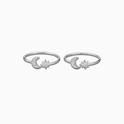Two silver rings with moon and star designs on a white background